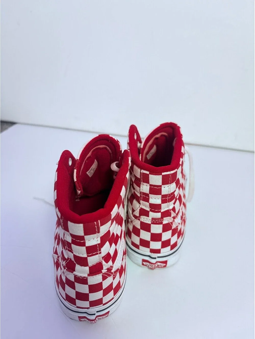 Vans red and white checkerboard high top sneakers